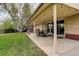 This covered backyard patio featuring lighting is perfect for relaxing and enjoying the spacious grassy backyard at 6544 E Alaska Dr, Denver, CO 80224