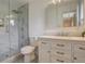 Modern bathroom featuring a glass shower, marble tile, and white vanity at 6544 E Alaska Dr, Denver, CO 80224