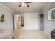 Bright bedroom featuring carpet flooring, a closet, and a ceiling fan at 6544 E Alaska Dr, Denver, CO 80224