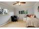 Cozy bedroom with natural lighting, plush carpeting, a ceiling fan, and a spacious desk at 6544 E Alaska Dr, Denver, CO 80224