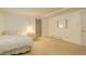 This cozy bedroom features neutral carpet and paint and a doorway leading to other parts of the home at 6544 E Alaska Dr, Denver, CO 80224