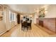 Dining room features hardwood floors, fireplace, a large table, and lots of natural light at 6544 E Alaska Dr, Denver, CO 80224