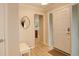 Bright entryway featuring a mirror, bench, and hardwood floors at 6544 E Alaska Dr, Denver, CO 80224