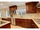 Gourmet kitchen featuring custom cabinetry, granite countertops, stainless steel appliances, and backsplash at 6544 E Alaska Dr, Denver, CO 80224