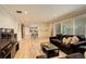 Open living area with hardwood floors, brick accent wall, and natural light, great for gatherings at 6544 E Alaska Dr, Denver, CO 80224