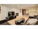Inviting living room featuring a painted brick fireplace and an open layout to the kitchen at 6544 E Alaska Dr, Denver, CO 80224