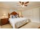 Bright and spacious bedroom featuring neutral colors, ceiling fan, and storage space at 6544 E Alaska Dr, Denver, CO 80224