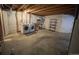 Unfinished basement area with laundry machines and ample space for storage at 1354 Avgare Way, Erie, CO 80516