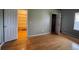 Bedroom with walk-in closet features neutral walls, hardwood floors and bright natural light at 1354 Avgare Way, Erie, CO 80516