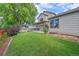 A spacious backyard with lush green grass and landscaping around the home at 5741 E 120Th Pl, Brighton, CO 80602