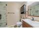 Updated bathroom with marble tile shower, modern vanity, and storage cabinet at 5741 E 120Th Pl, Brighton, CO 80602