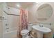Well-lit bathroom featuring a shower-tub combo and a modern pedestal sink at 5741 E 120Th Pl, Brighton, CO 80602