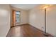Bedroom features hardwood floors, a large window, and ample natural light at 5741 E 120Th Pl, Brighton, CO 80602