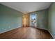 Cozy bedroom features hardwood floors, soft green walls and bright natural light at 5741 E 120Th Pl, Brighton, CO 80602
