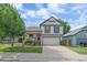 Charming two-story home with a well-manicured front yard and an attached two-car garage at 5741 E 120Th Pl, Brighton, CO 80602