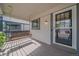 Inviting front porch featuring a charming wooden swing and stylish entry door at 5741 E 120Th Pl, Brighton, CO 80602