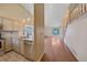 Modern kitchen featuring stainless steel appliances and adjacent hardwood floor living area at 5741 E 120Th Pl, Brighton, CO 80602