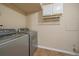 Laundry room featuring a washer and dryer with overhead cabinets and neutral colored walls at 5741 E 120Th Pl, Brighton, CO 80602