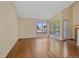 Hardwood floors, large window overlooking tree-filled yard in naturally lit living room at 5741 E 120Th Pl, Brighton, CO 80602