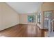 Open living space with hardwood floors, large window overlooking a tree-filled yard at 5741 E 120Th Pl, Brighton, CO 80602