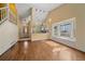 Bright, open-concept living space connecting the kitchen and living room, and hardwood floors at 5741 E 120Th Pl, Brighton, CO 80602