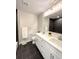 Modern bathroom featuring a double vanity, sleek black tile accents, and updated fixtures at 2090 S Clinton St, Denver, CO 80231