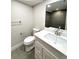 Bathroom featuring a vanity with a marble countertop, grey floor tiles, and modern fixtures at 2090 S Clinton St, Denver, CO 80231