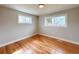 Bright bedroom with gleaming hardwood floors and two large windows at 2090 S Clinton St, Denver, CO 80231