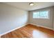 Empty bedroom with new windows and hardwood floors, ready for your personal touch at 2090 S Clinton St, Denver, CO 80231