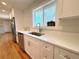 Updated kitchen featuring stainless steel appliances, a white sink, and light countertops at 2090 S Clinton St, Denver, CO 80231