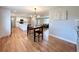 Open-concept floor plan showcases dining area adjacent to a bright kitchen with a white island at 2090 S Clinton St, Denver, CO 80231