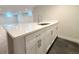 Wet bar with white cabinets, stainless steel sink and faucet, and tile flooring at 2090 S Clinton St, Denver, CO 80231