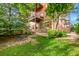 Charming backyard with lush greenery, stone patio, and seating area perfect for relaxing and entertaining at 2351 Federal Blvd # 401, Denver, CO 80211