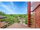 Balcony overlooking city with wood decking and metal railing with trees and buildings below at 2351 Federal Blvd # 401, Denver, CO 80211