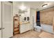 Full bathroom features a tiled shower, modern vanity with sink, mirror, lighting, and built-in storage at 2351 Federal Blvd # 401, Denver, CO 80211