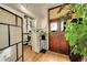 Inviting entryway featuring a wood door, hardwood floors, plants, and a window with a view at 2351 Federal Blvd # 401, Denver, CO 80211