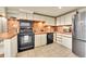 Kitchen featuring tile floors and countertops, plus updated appliances and ample cabinetry at 2351 Federal Blvd # 401, Denver, CO 80211
