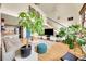 Inviting living room with hardwood floors, a modern staircase, high ceilings, and is filled with natural light and plants at 2351 Federal Blvd # 401, Denver, CO 80211