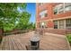 Spacious wooden patio with seating and a fire pit, ideal for enjoying outdoor gatherings and views at 2351 Federal Blvd # 401, Denver, CO 80211