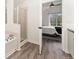 Bathroom featuring a large shower, soaking tub, and seamless flow into the main bedroom at 10760 Eliot Cir # 204, Denver, CO 80234