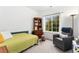Cozy bedroom with a large window, reading chair, and wood accents at 10760 Eliot Cir # 204, Denver, CO 80234