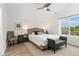 Bright bedroom with a ceiling fan, large window, and plush accents at 10760 Eliot Cir # 204, Denver, CO 80234