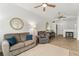 Open concept living room with hardwood floors and a dining area under a ceiling fan at 10760 Eliot Cir # 204, Denver, CO 80234