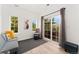 Cozy sitting room with a sofa, chair, and access to a balcony through sliding glass doors at 10760 Eliot Cir # 204, Denver, CO 80234