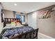 Fun bedroom showcasing sports team decorations and a sliding-door closet at 4849 S Pitkin Way, Aurora, CO 80015
