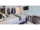 Bright bedroom featuring a large bed, closet space, and soft natural light, creating a comfortable retreat at 4849 S Pitkin Way, Aurora, CO 80015