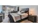 Relaxing bedroom featuring a large bed with decorative pillows, a modern dresser, and soft natural light at 4849 S Pitkin Way, Aurora, CO 80015