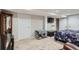 Bedroom area featuring a large bed, adjacent to a living area with tv at 4849 S Pitkin Way, Aurora, CO 80015
