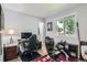 Bright bedroom features a gaming setup, racing seat and hockey stick by the window, adding a touch of recreation at 4849 S Pitkin Way, Aurora, CO 80015