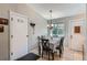 Bright dining area with a chandelier, tile floors, and easy access to other rooms at 4849 S Pitkin Way, Aurora, CO 80015